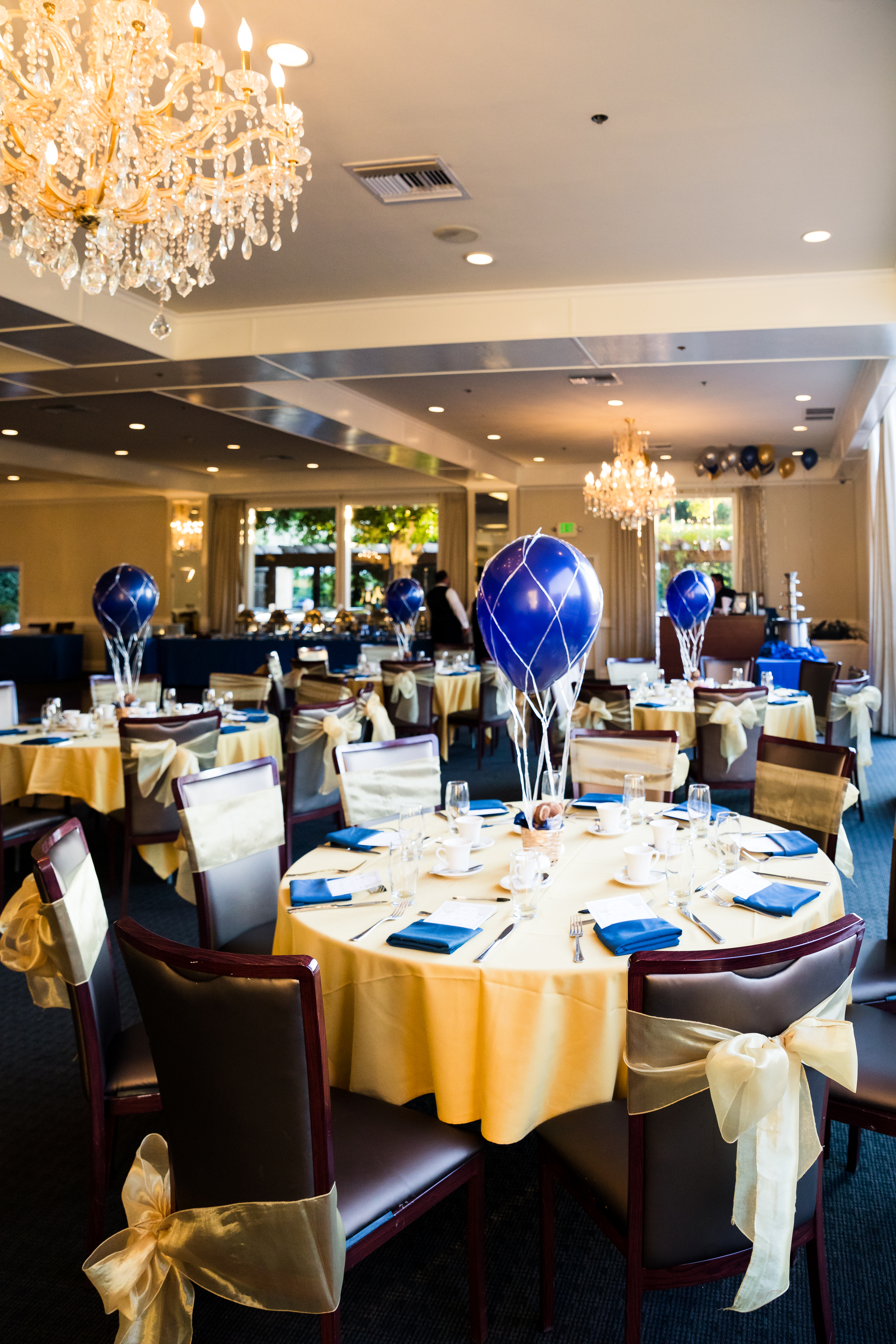 Coordinated hot-air-balloon baby shower tables with blue and champagne details